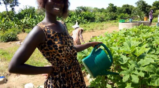 jeune agripreneuse arrosant son champ